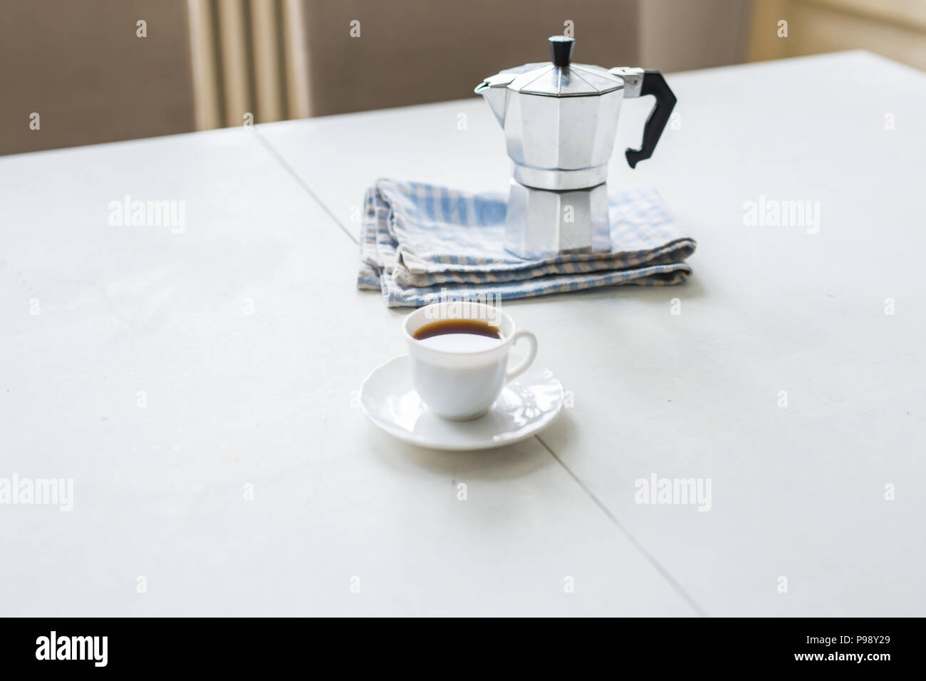 https://c8.alamy.com/compes/p98y29/taza-de-cafe-cafetera-hervidor-de-agua-sobre-una-mesa-blanca-p98y29.jpg