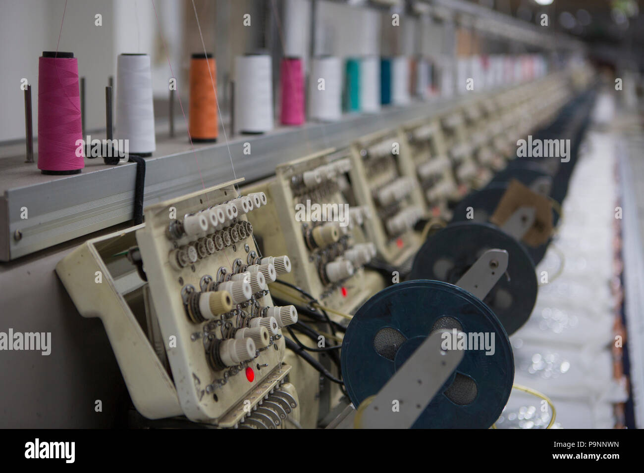 Pericia Ofensa Conversacional Máquinas de coser, imprimir un sequin diseño en una camiseta de algodón bio  en una fábrica, donde el algodón orgánico se utiliza para hacer la ropa,  Indore, India Fotografía de stock -