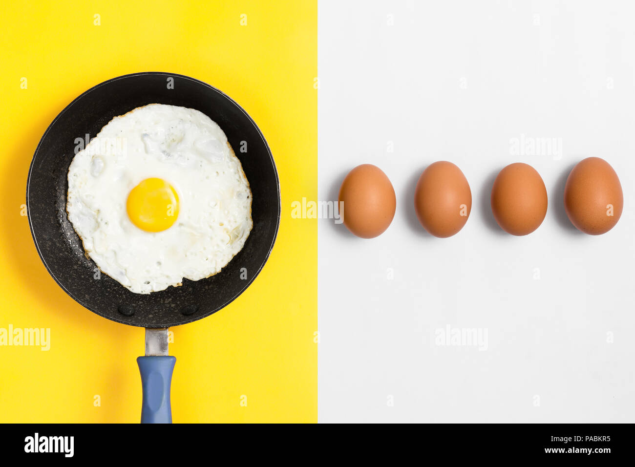 Split color plano imagen laicos con huevo cocido en una sartén los huevos crudos y alineadas. Foto de stock