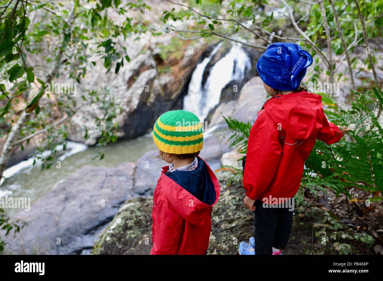 Dos niños mirando poco millstream falls, Millstream falls national park, Atherton Tablelands, Queensland, Australia Foto de stock