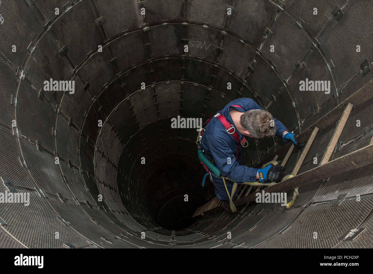 SASEBO, Japón (Marzo 20, 2015), Tim Mastbergen trepa por una escalera en el tubo de escape del motor principal a bordo del USS Littoral Combat Ship (LCS Fort Worth 3). En el puerto de Fort Worth está realizando una breve y la rutina de mantenimiento disponibilidad durante 16 meses de implementación rotacional en apoyo del Pacífico Indo-Asia reequilibrar. Mastbergen es un jubilado mecánico jefe técnico del sistema de turbina de gas. Foto de stock