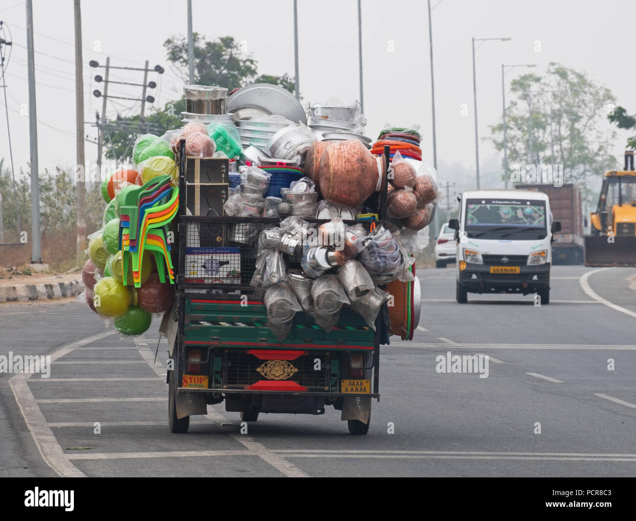 Sobrecargar el vehículo comercial llevando enseres en una carretera principal al sur de Mysore, India. Cargas excesivas son habituales en las carreteras indias Foto de stock