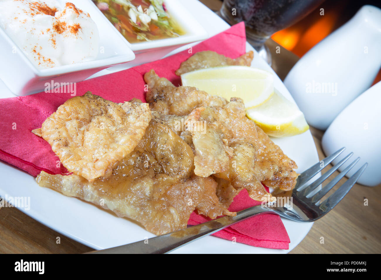 Un English pub/restaurante plato plato de piel de pollo asado con mayonesa con pimentón y ajo y