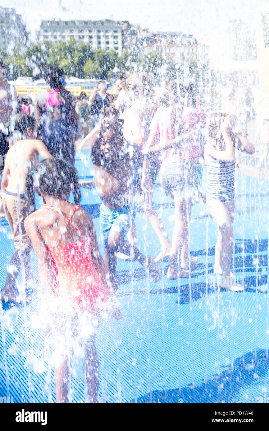 Los niños se divierten y refrescarse durante la ola de calor del verano en el centro de Londres Foto de stock