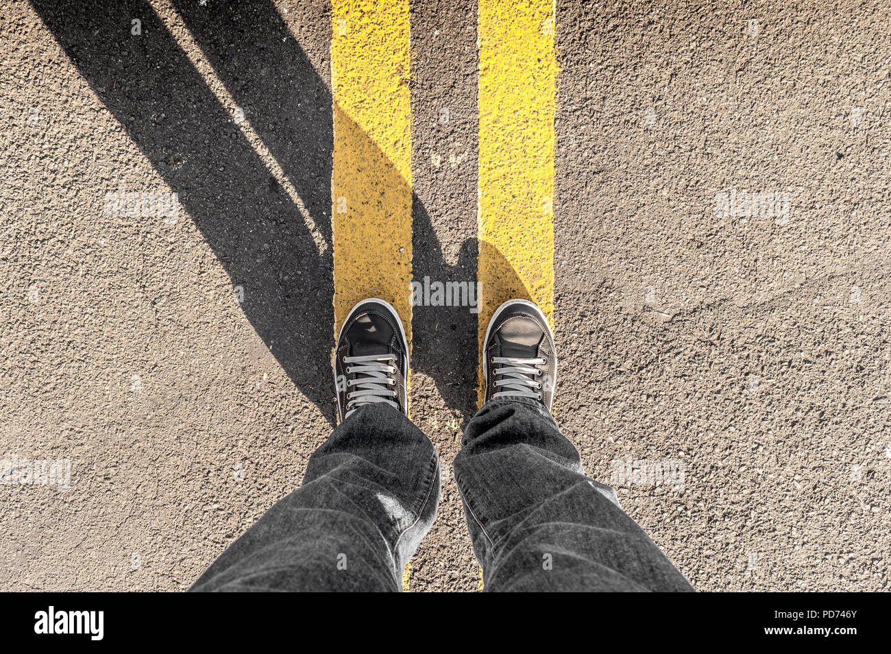 Perspectiva Personal de persona las piernas y street's líneas amarillas Foto de stock