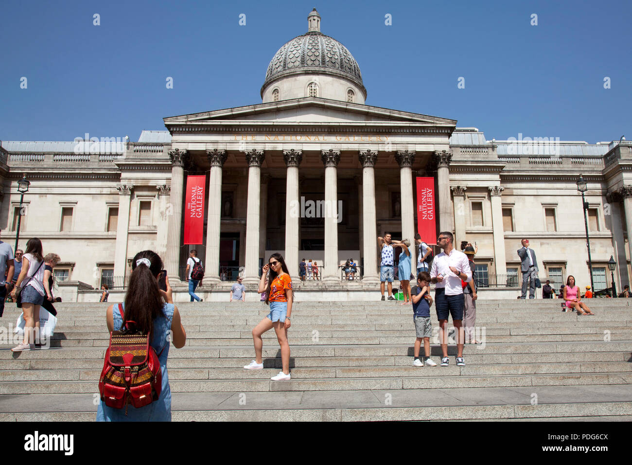 Londres, Trafalgar Square, la National Gallery pasos, las niñas posando para la foto Foto de stock