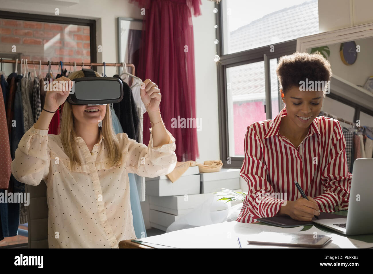 Los diseñadores de moda con casco de realidad virtual y tableta gráfica Foto de stock
