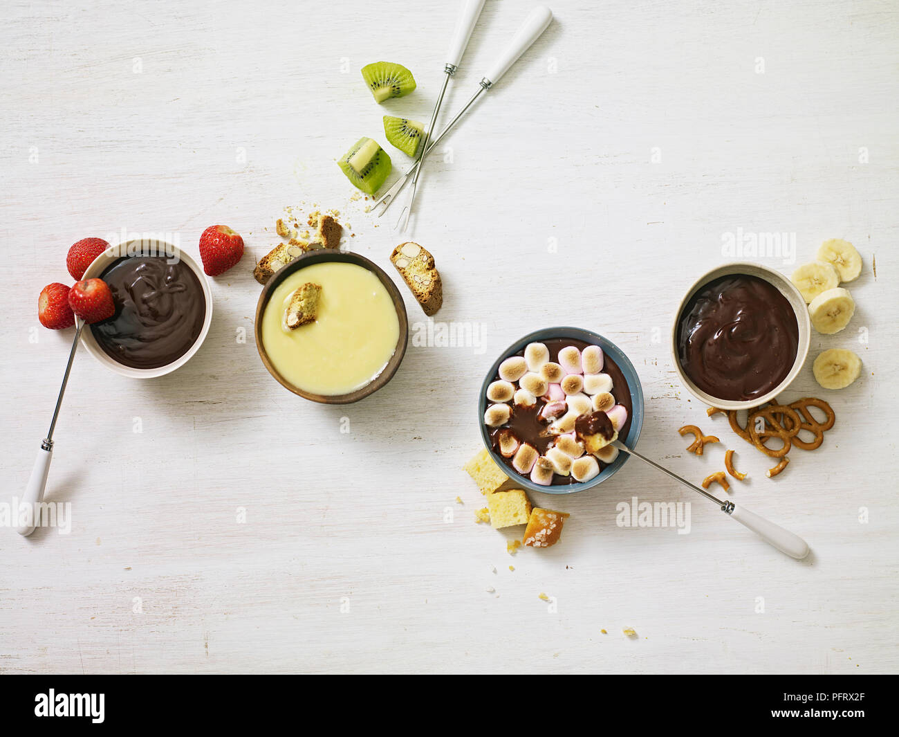 Las fondues de chocolate, fondue de chocolate y mantequilla de maní, chocolate clásica fondue, fondue de chocolate blanco y coco Foto de stock