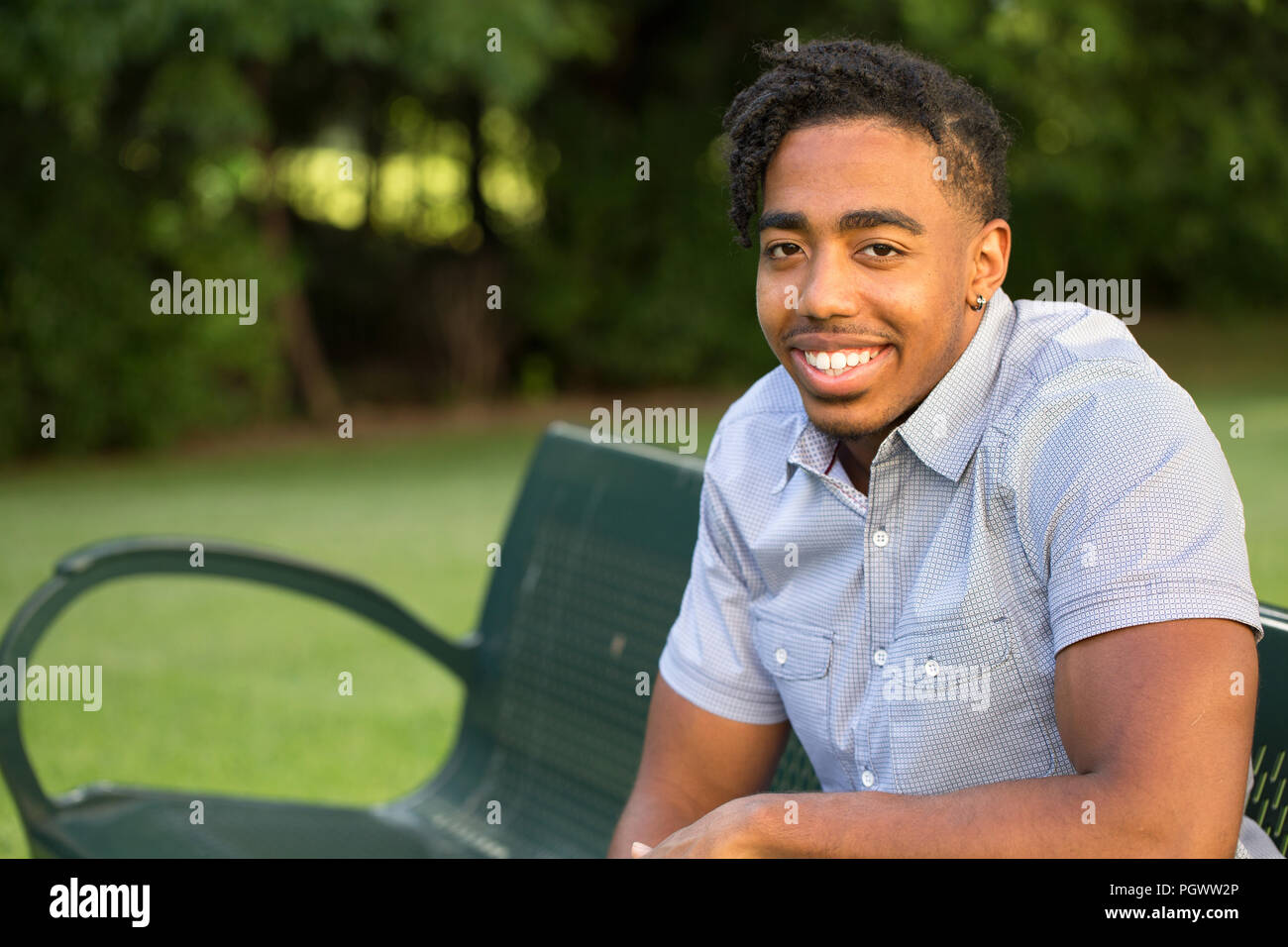 Joven apuesto hombre afroamericano sonriendo fuera. Foto de stock