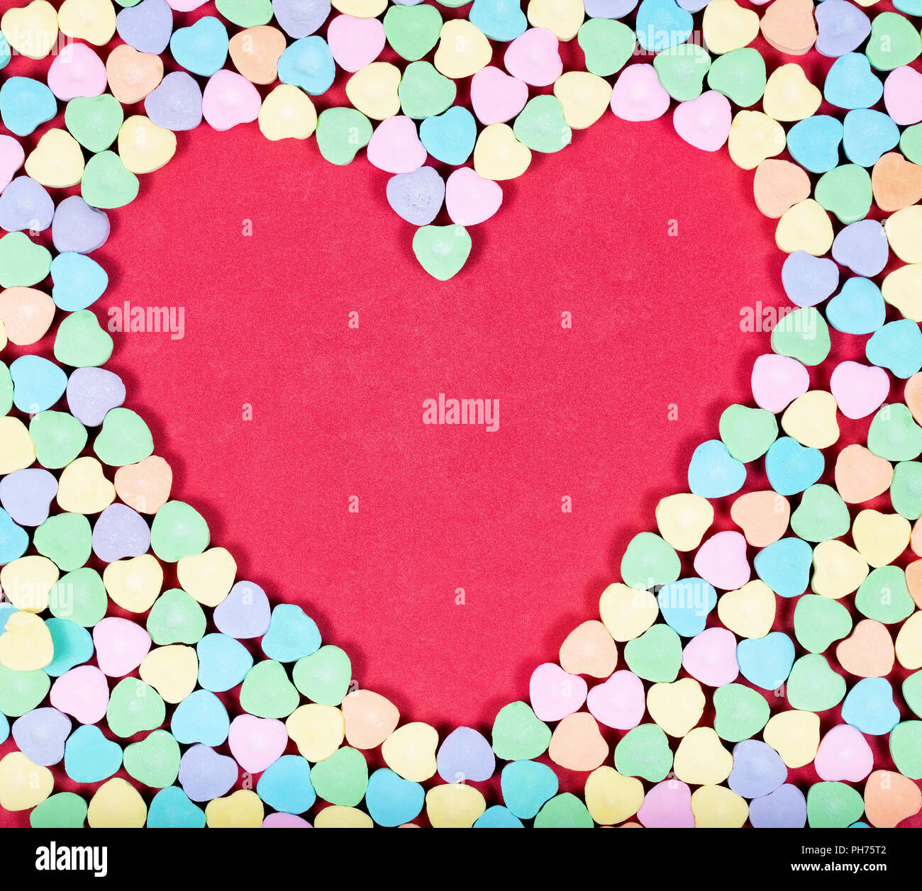 El espacio en blanco del corazón con caramelos de colores en el exterior Foto de stock