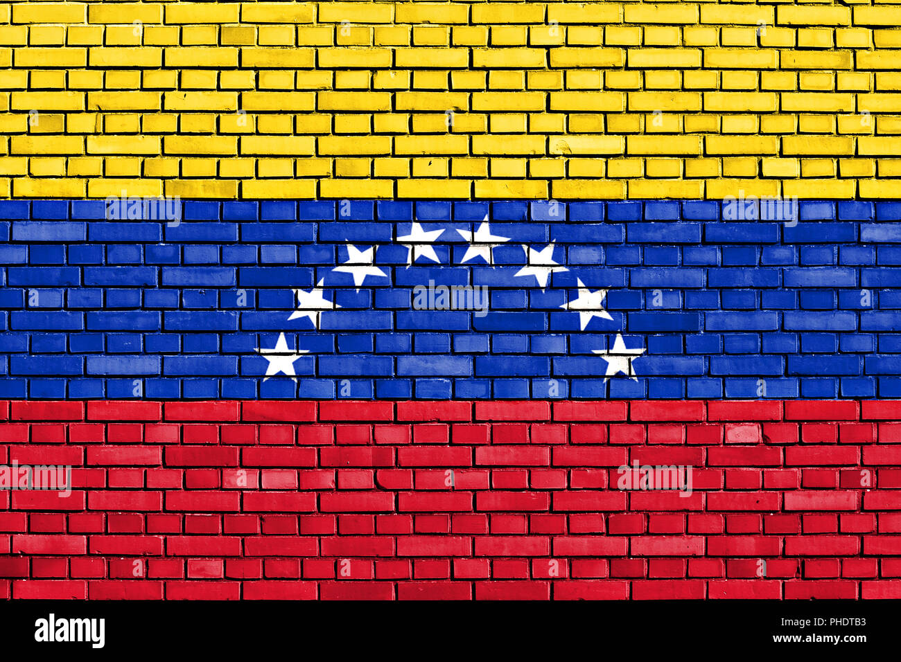 Bandera de Venezuela pintada sobre pared de ladrillo Foto de stock
