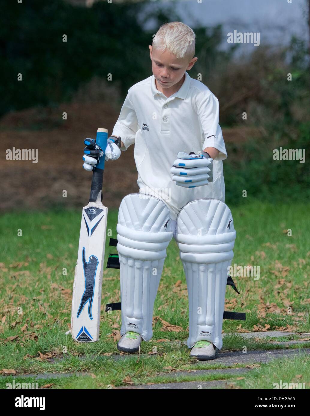Un joven en cricket marcha a un segundo partido entre once y Tintwistle Mottram Foto de stock
