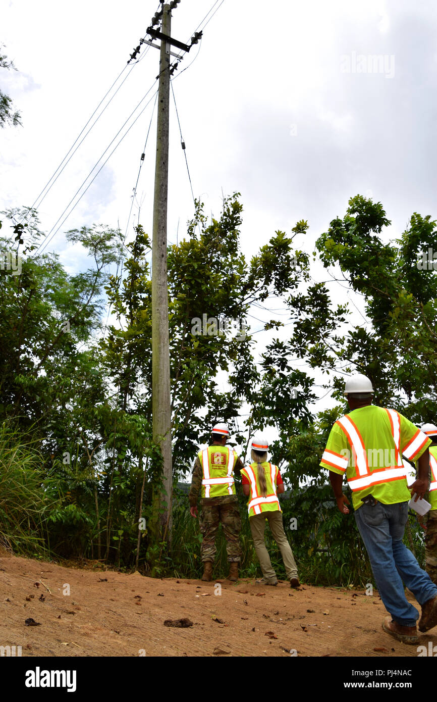 El Cuerpo de Ingenieros del Ejército de EE.UU. Recuperación de Task Force Commander MAJ Scotty Autin inspecciona la labor de estabilización ambiental que condujo al reparar power pole, Isabela, Puerto Rico, 31 de agosto de 2018. El Cuerpo de Ingenieros está supervisando la estabilización ambiental en 53 sitios a lo largo de toda la isla, con el fin de restaurar los sitios perturbados durante la misión de restablecimiento de energía de emergencia. Foto de stock
