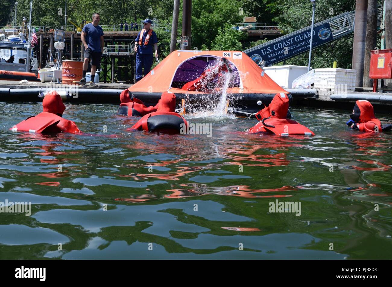 Los miembros de la Mesa Redonda de Seguridad Patria de Washington práctica  entrada en una balsa salvavidas inflables en el río Willamette en los  muelles de la Unidad de Seguridad Marina en