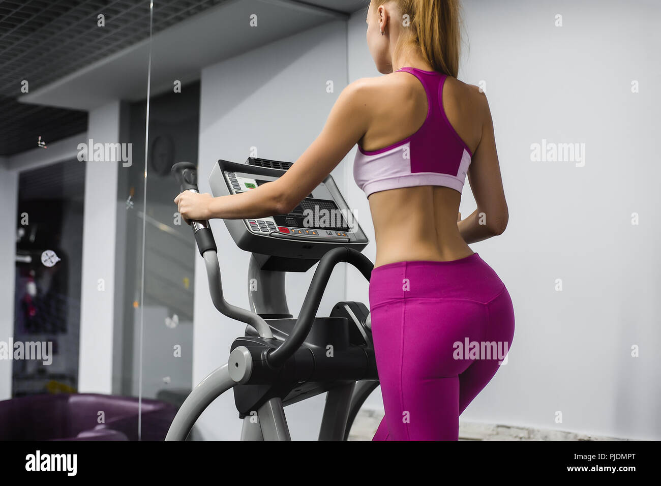 Mujer en el gimnasio con equipamiento de ejercicio Foto de stock