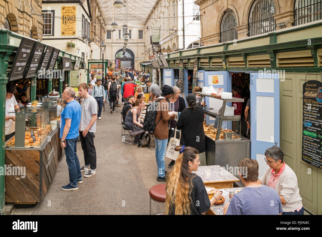 Gente comiendo en los mercados de San Nicolás, Bristol, Inglaterra, Reino Unido. Foto de stock
