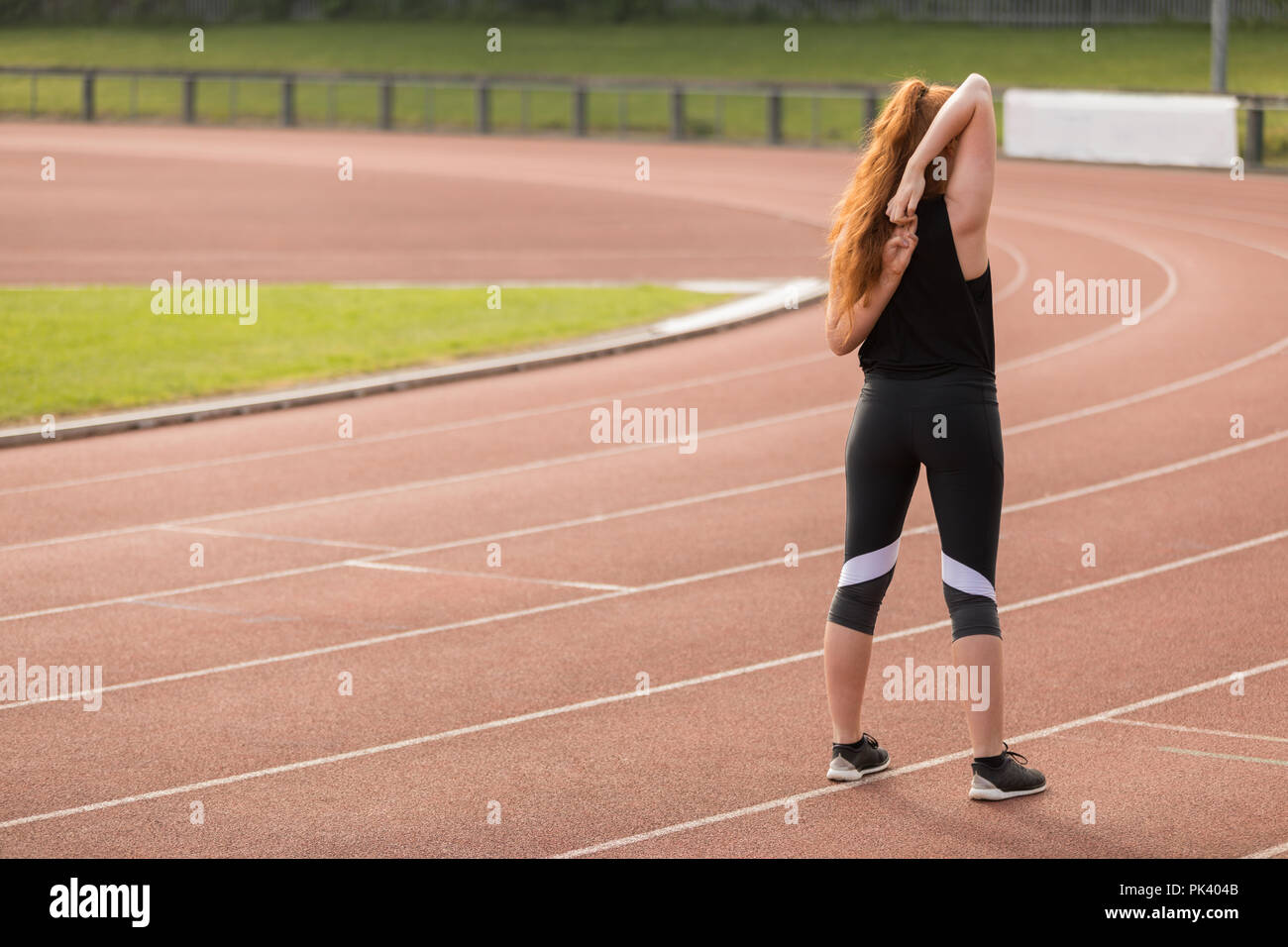Atletismo femenino ejerce sobre una pista de atletismo Foto de stock