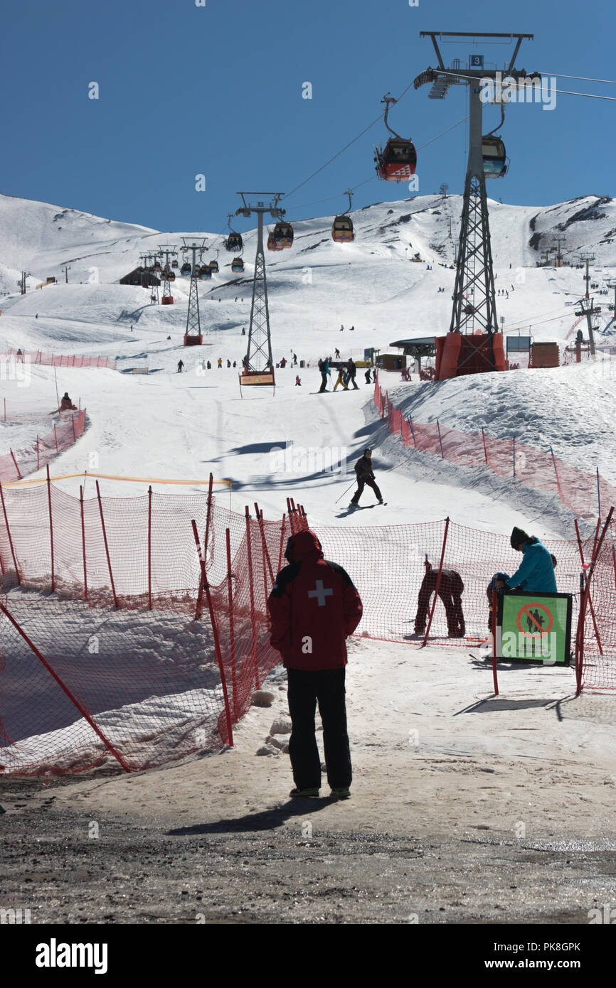Persona de pie delante de Valle Nevado Ski Lift , algunas personas en torno a disfrutar del invierno. Esto es un gran lugar para practicar el esquí y el snowboard en las Montañas Andinas Foto de stock
