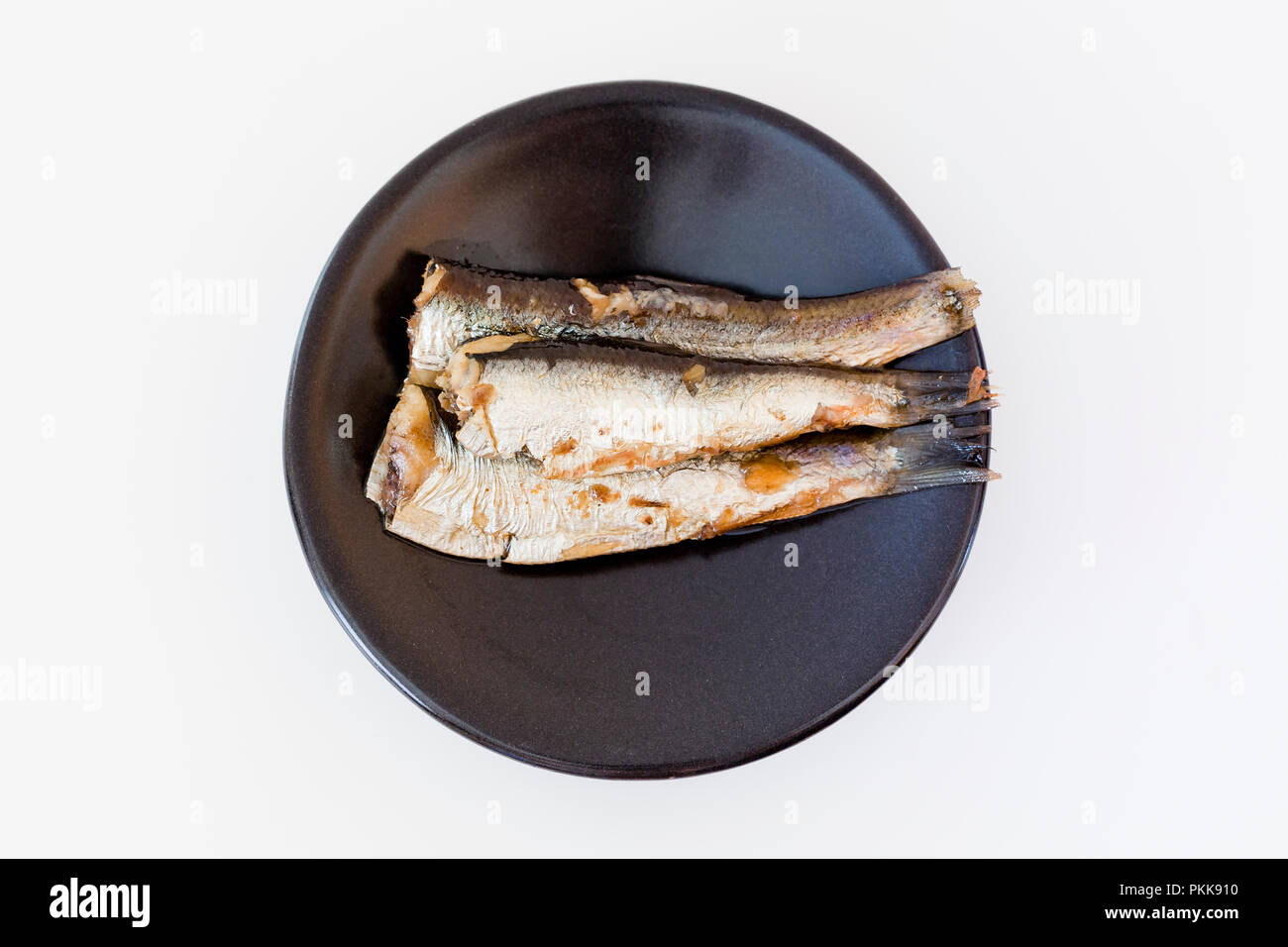 Las sardinas (aka pilchards) marinados en aceite de oliva en dish - EE.UU. Foto de stock