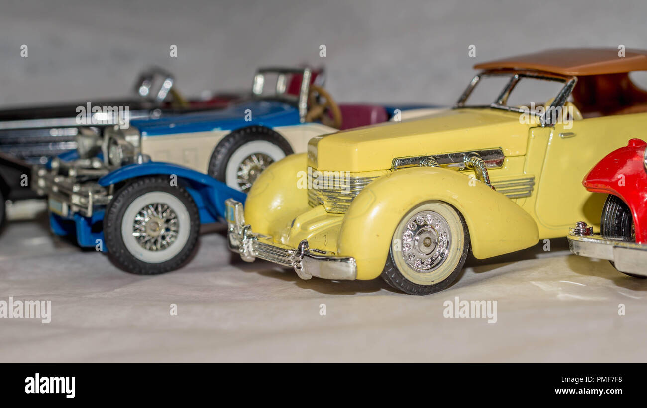 Colección de réplicas en miniatura de coches antiguos de juguete sobre un  fondo blanco.