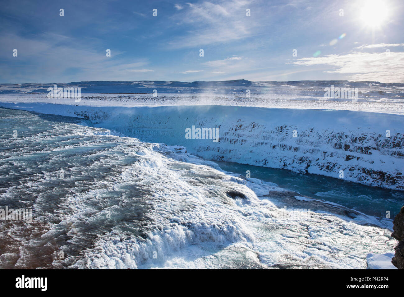 Brota el agua del río glacial en caídas de la cascada de Gullfoss y las montañas en el paisaje glacial del sur de Islandia Foto de stock
