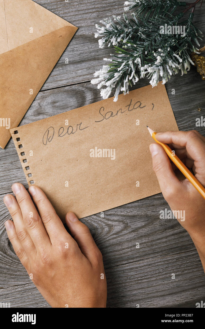 Carta a Santa Claus. Decoraciones de Navidad y una hoja de papel con lugar  para el texto en una tabla de madera, vista superior Fotografía de stock -  Alamy