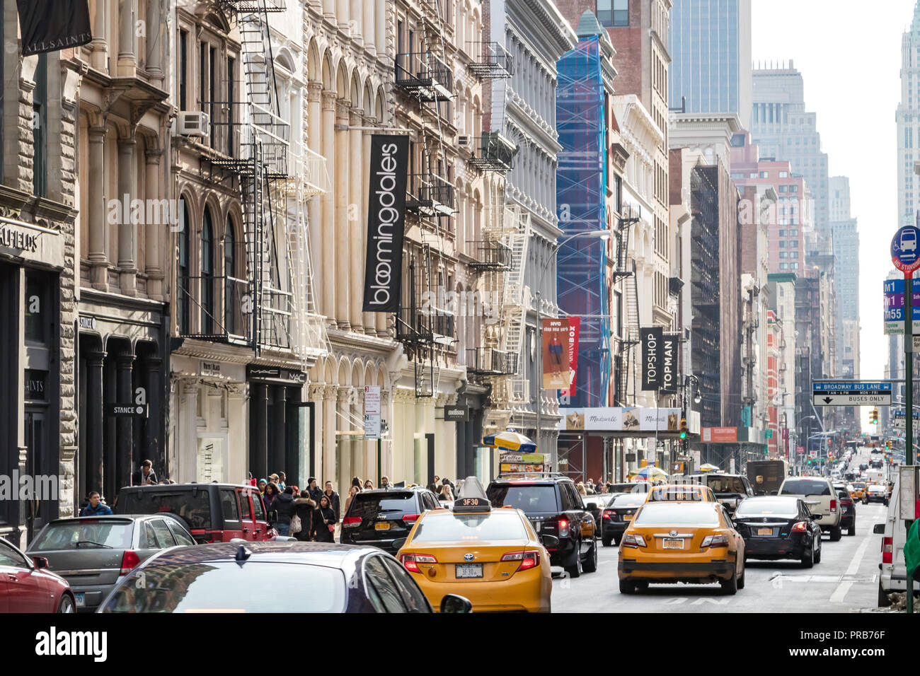 La CIUDAD DE NUEVA YORK, circa 2018: unidades de Tráfico por Broadway como multitudes de personas recorren las aceras de SoHo, en un día ocupado en Manhattan, Ciudad de Nueva York. Foto de stock