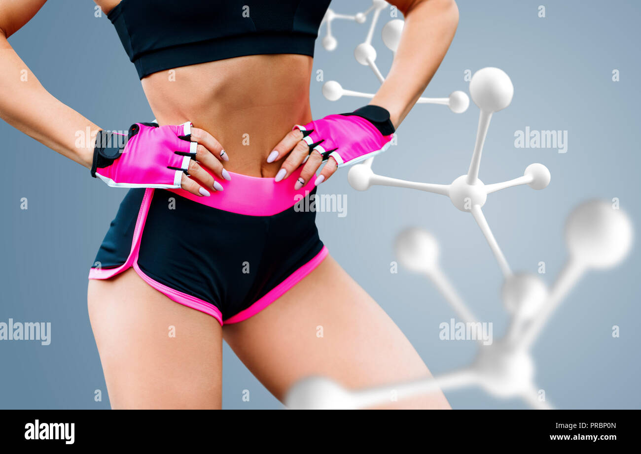 Gimnasia atlética mujer de pie cerca de white cadena de moléculas. Foto de stock