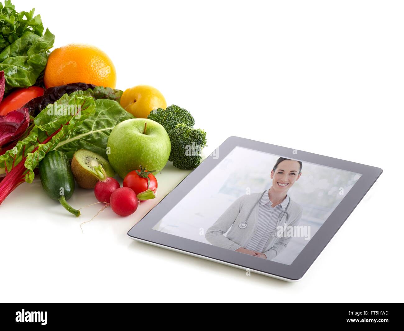 Frutas y hortalizas frescas con imagen del médico sobre la tableta digital, foto de estudio. Foto de stock