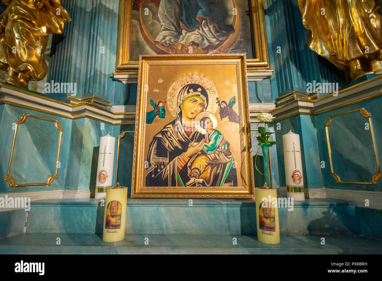 Altar decorado con velas muestra una pintura que representa a la Virgen María sosteniendo a Jesús, Zwoleń, Masovian voivodato, Polonia Foto de stock
