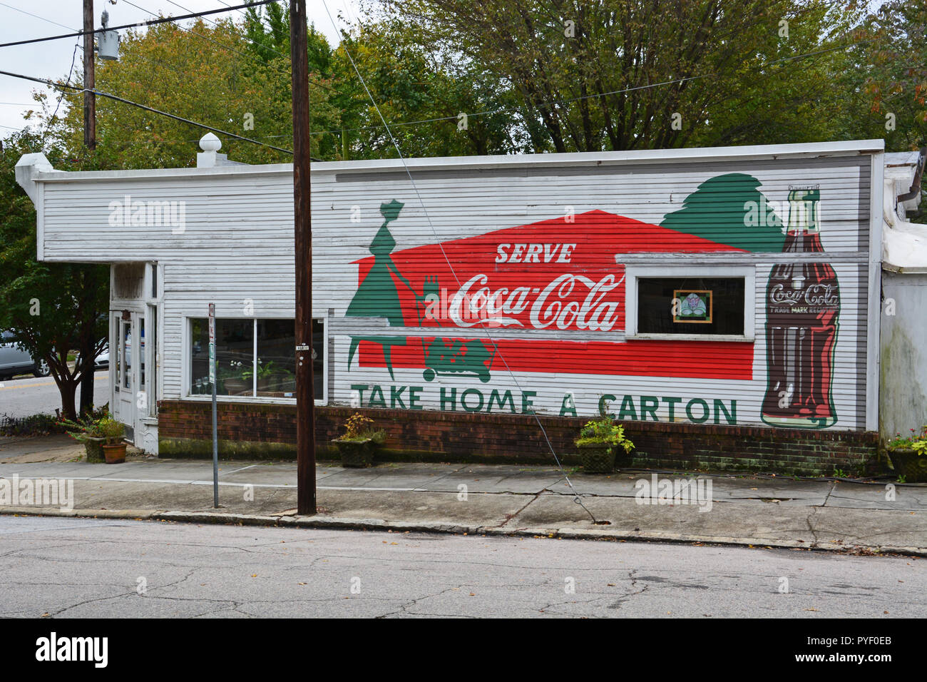 Un signo clásico de Coca Cola en el lateral de una antigua tienda de la esquina en el histórico barrio de Oakwood de Raleigh, Carolina del Norte. Foto de stock