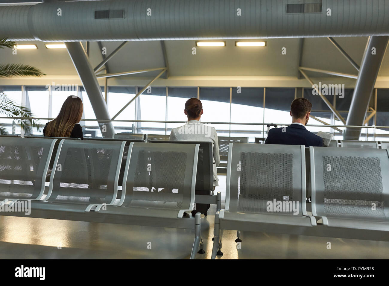 La gente de negocios como a los pasajeros en la terminal del aeropuerto mientras espera el vuelo de conexión Foto de stock