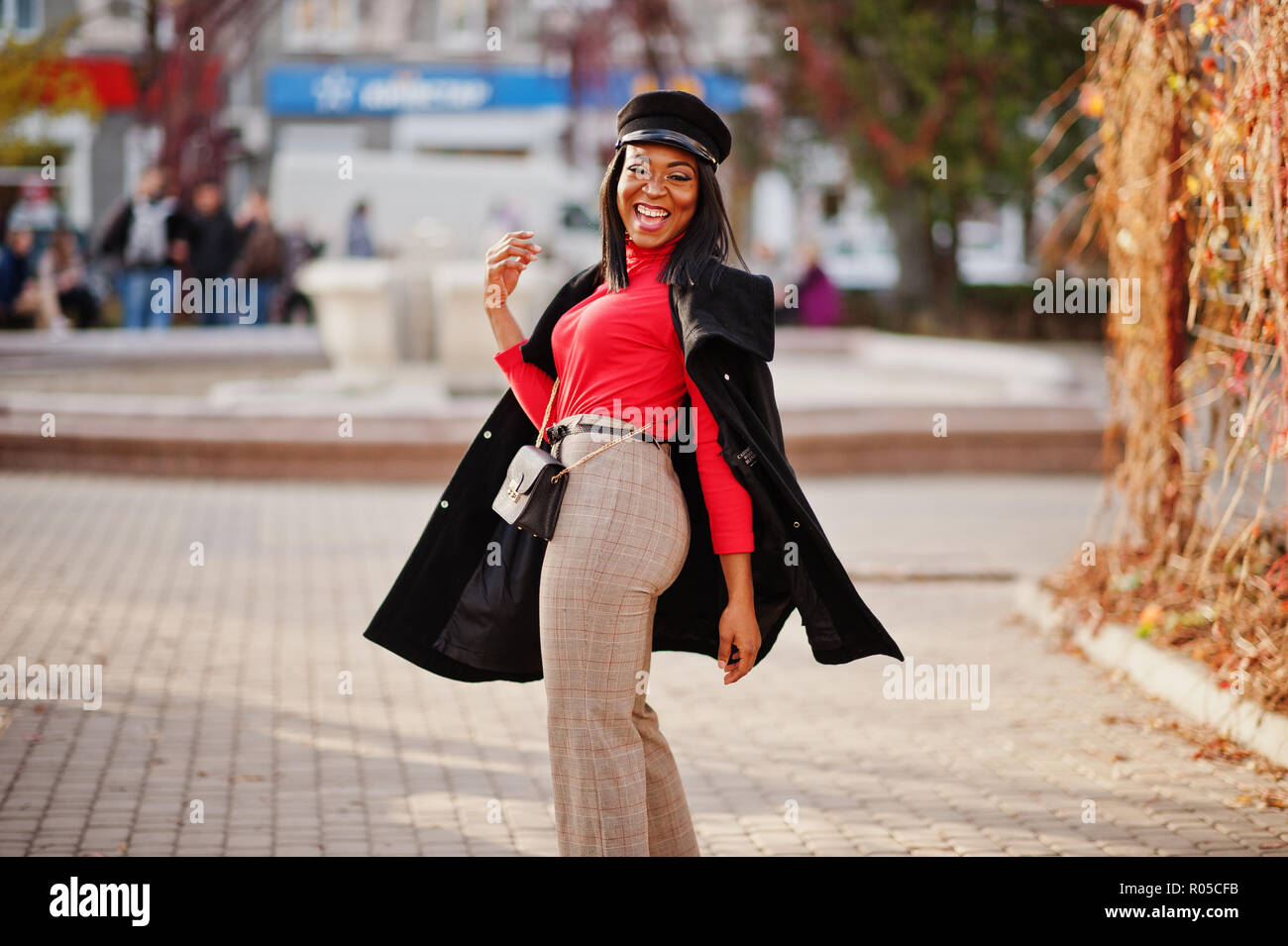 African American fashion girl en escudo y repartidor de prensa cap, con  bolso planteados en la calle Fotografía de stock - Alamy