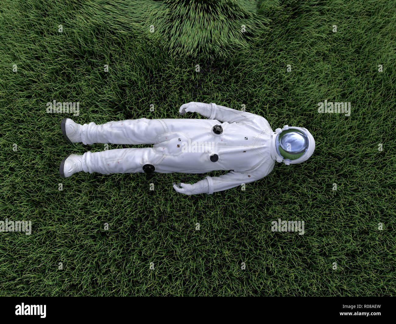 El astronauta tumbado sobre el césped Foto de stock