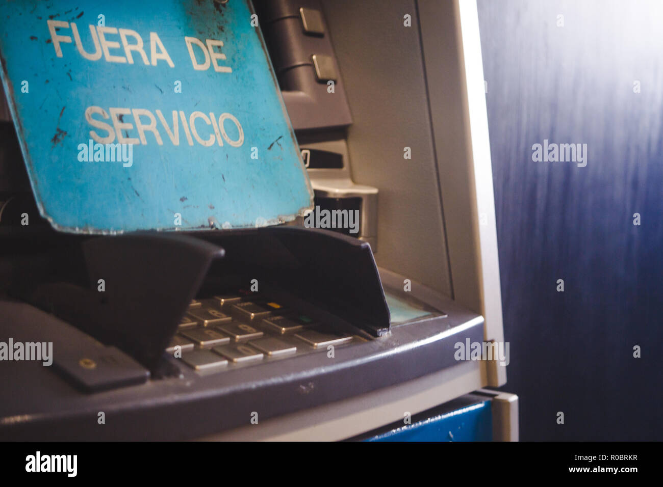 Teclado de pin de retiro de efectivo en cajeros automáticos de la máquina con un cartel que dice "fuera de servicio" en español Foto de stock