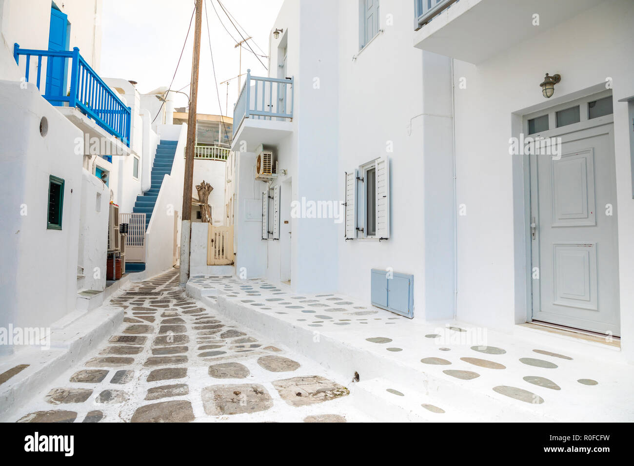 Las casas tradicionales con puertas y ventanas azules en las estrechas calles del pueblo griego en Mykonos, Grecia Foto de stock