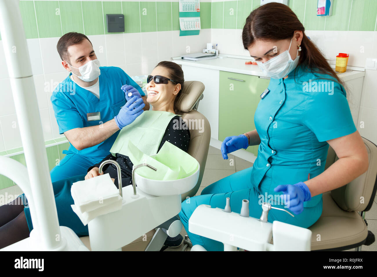 La gente, Medicina, Estomatología y concepto de salud - macho dentista y  asistente dental con luz y espejo de curado el tratamiento de dientes al  paciente Fotografía de stock - Alamy
