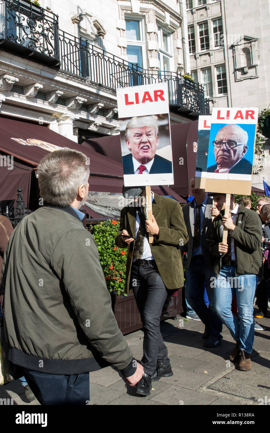 Londres, Reino Unido. El 20 de octubre de 2018. Los manifestantes llevan pancartas teniendo las imágenes del Presidente Trump y Rupert Murdoch y la palabra "mentiroso" en el pueblo Foto de stock