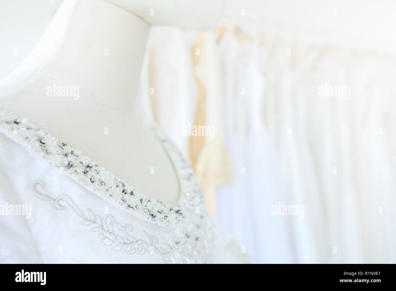 Closeup hermoso vestido nupcial en un modelo en perchas wedding dress store Foto de stock