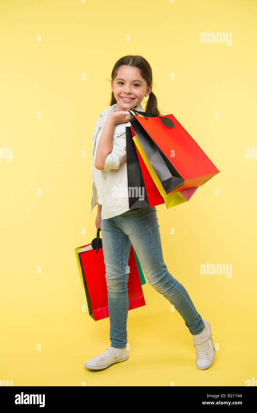 Cambiar mi estilo. Niño lindo fashionista shopping. Kid Felices compras en el mall. Chico Chica feliz rostro sonriente transporta paquetes de racimo de fondo amarillo. Chica shopaholic le gusta comprar ropa de Cambiar mi estilo. Niño lindo fashionista shopping. Kid Felices compras en el mall. Chico Chica feliz rostro sonriente transporta paquetes de racimo de fondo amarillo. Chica shopaholic le gusta comprar ropa de