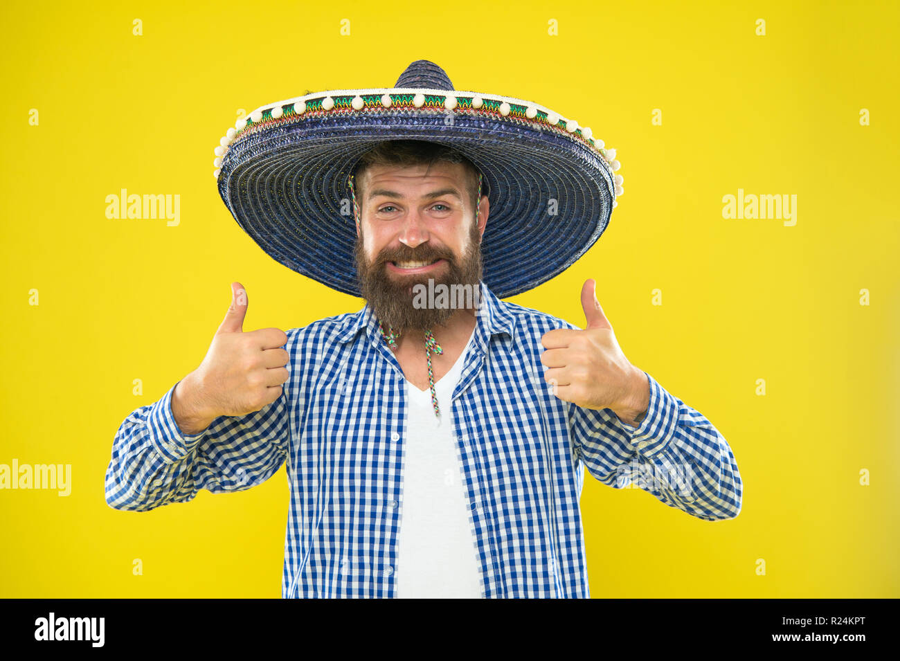 Chico mexicano feliz traje festivo listo para celebrarlo. El hombre barbado  alegre chico llevar sombrero Mexican Hat fondo amarillo. Concepto de fiesta  mexicana. Celebrar la tradicional fiesta mexicana. Permite divertirse  Fotografía de