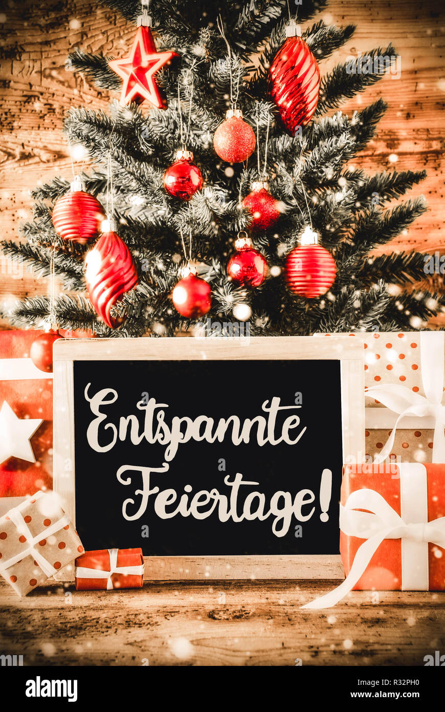 Árbol vertical, regalos, Caligrafía Entspannte Feiertage significa ¡Feliz Navidad! Foto de stock