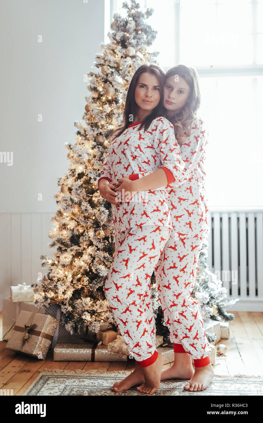 joven madre y su hija en pijamas durante Navidad Fotografía de - Alamy