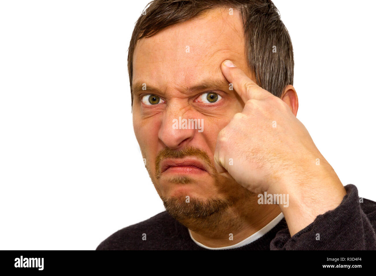 El hombre enojado con el dedo en la frente Foto de stock