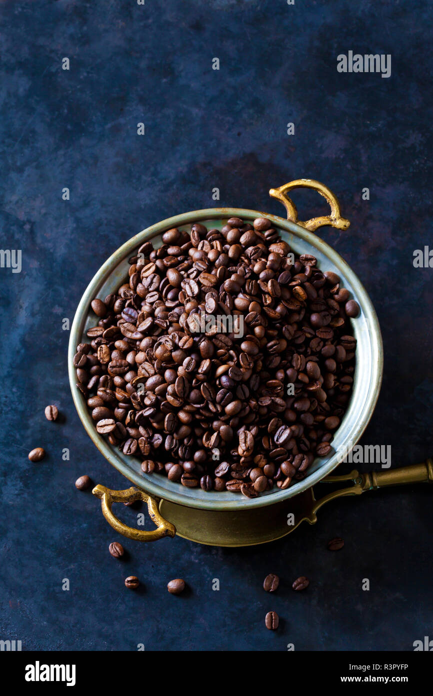 Los granos de café recién tostados en un tazón Foto de stock