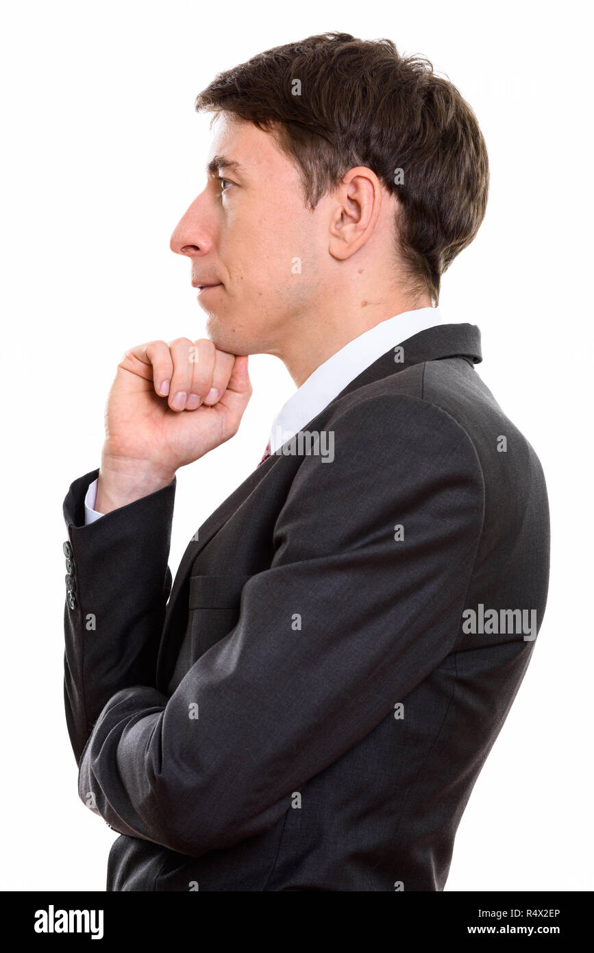 En la vista de perfil del empresario pensando con la mano en la barbilla Foto de stock