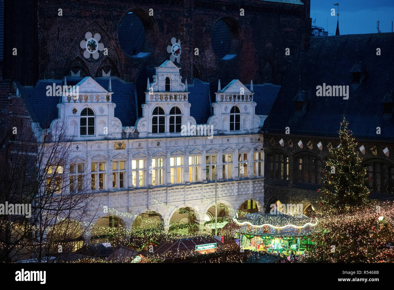 29 de noviembre de 2018, Schleswig-Holstein Lübeck: la iluminación del Mercado de Navidad de Lübeck ilumina la fachada renacentista de la Ciudad Hanseática Hall. La primera Navidad decorado mercados están abiertos en estos días. Más seguirán en los próximos días. Foto: Rainer Jensen/dpa Foto de stock