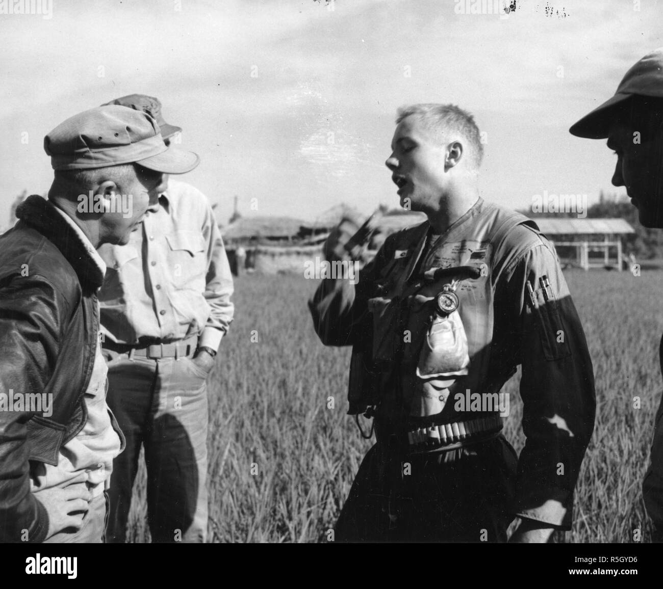 Ensign Neil A. Armstrong, US Navy (y futuro astronauta de la NASA y el primer hombre en caminar sobre la Luna durante la misión Apolo 11) narra el Coronel Carlson A. Roberts, marines, y otros dos hombres no identificados de la molestia que le llevó a rescatar de su F9F "Panther" jet en Corea, 18 de septiembre de 1951. Foto de stock