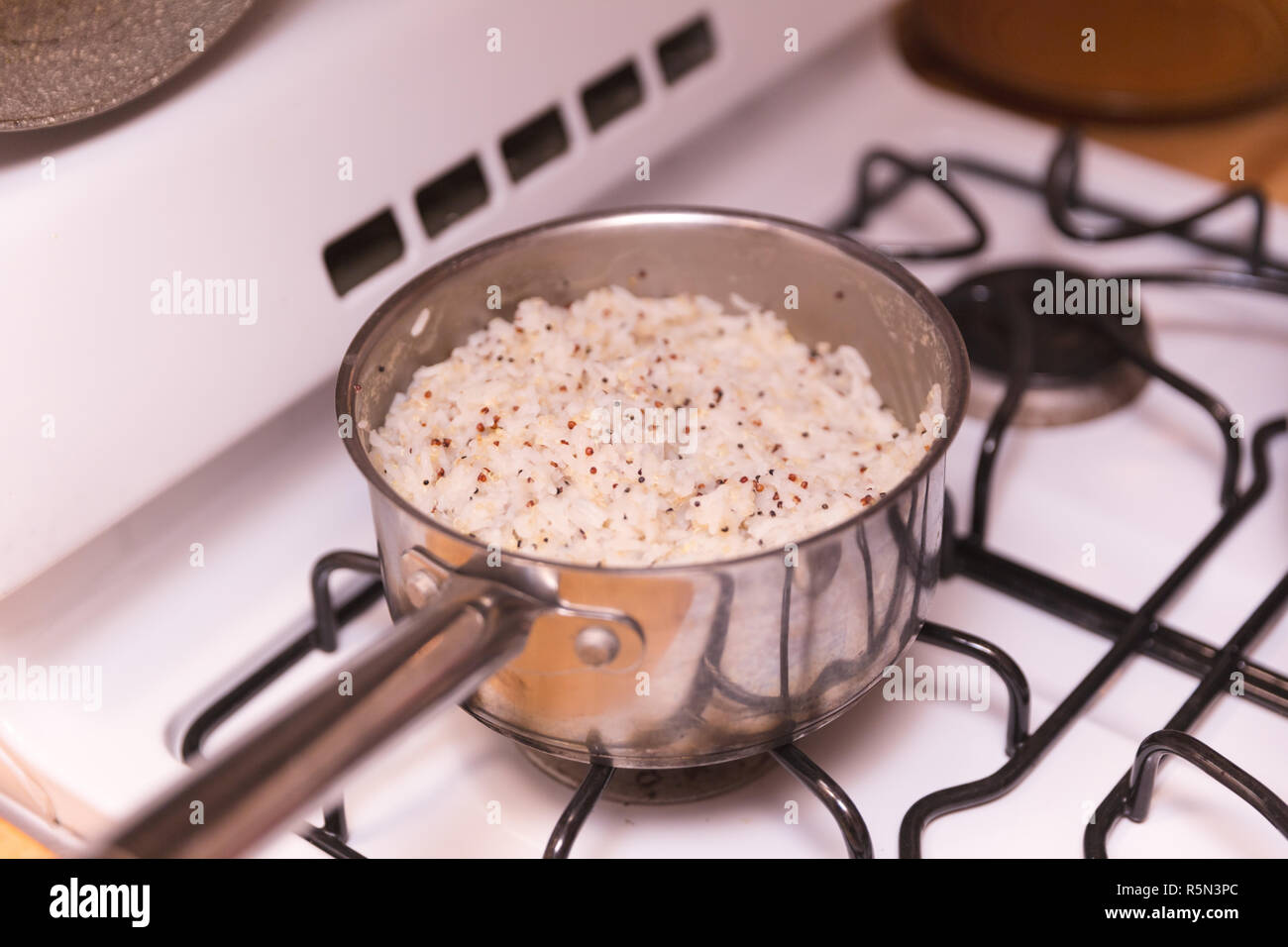 Primer plano de una olla para cocinar arroz en un quemador de gas