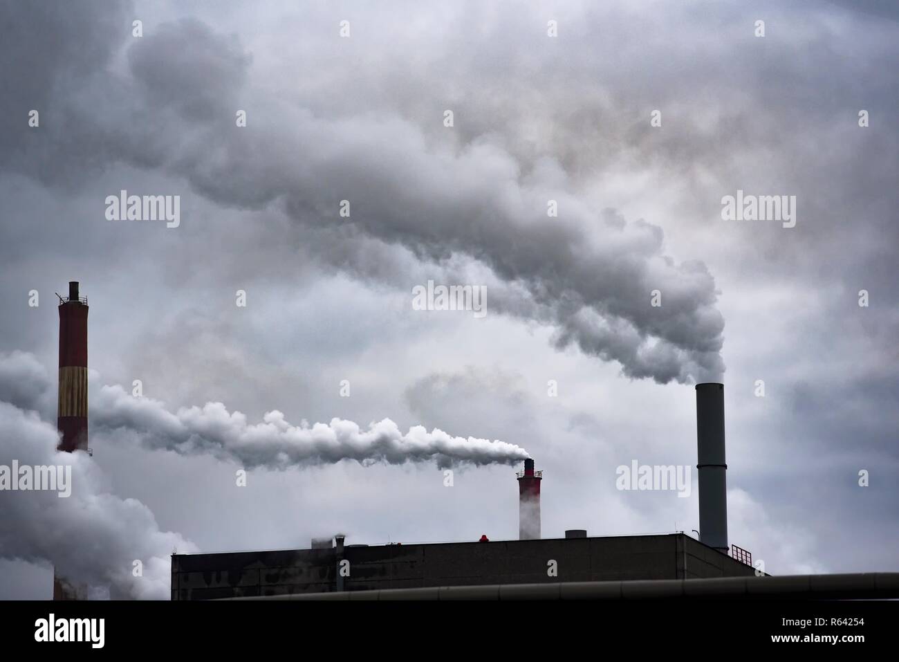 Fábrica de chimeneas humeantes contaminando el medio ambiente y el aire. Foto de stock